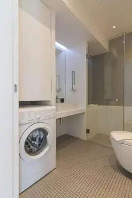 a bathroom with a washing machine and a toilet at Athens Trikoupi Suite E2 in Athens