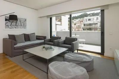 a living room with a couch and a table at Athens Trikoupi Suite E2 in Athens