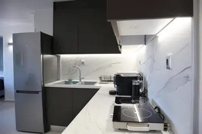 a kitchen with a coffee maker on a counter at Golden Sand Suites in Anavissos