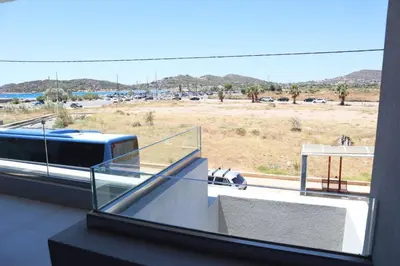 a balcony with a view of a parking lot at Golden Sand Suites in Anavissos