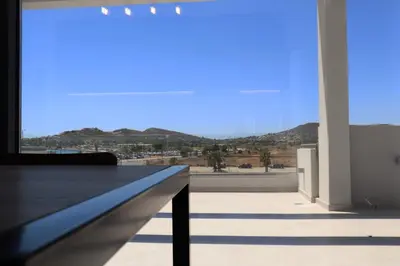 a room with a large window with a view of the desert at Golden Sand Suites 2 in Anavissos