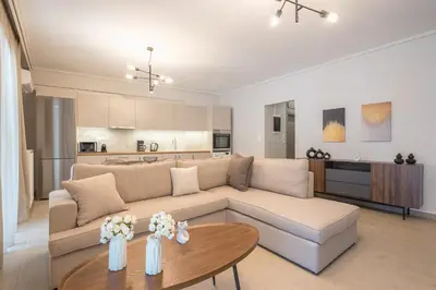 a living room with a couch and a table at Chic 2BR Apartment with Balcony in Athens