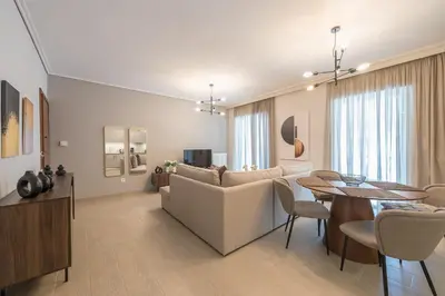 a living room with a couch and a table at Chic 2BR Apartment with Balcony in Athens