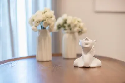 a toy dog sitting on a table with vases of flowers at Chic 2BR Apartment with Balcony in Athens