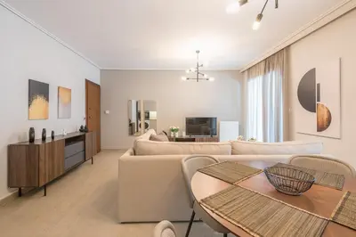 a living room with a couch and a table at Chic 2BR Apartment with Balcony in Athens