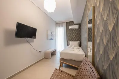 a bedroom with a bed and a mirror and a tv at Chic 2BR Apartment with Balcony in Athens