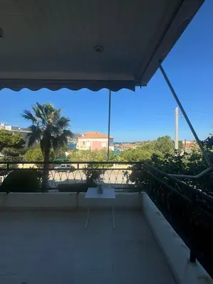 a table on a balcony with a view of the ocean at Artist Home in Porto Rafti
