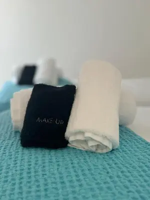 a towel that says wake up on a bed at Artist Home in Porto Rafti