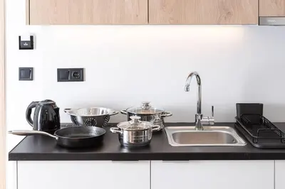 a kitchen counter with pots and pans and a sink at The Meta Stay - Rooftop Access 1 bedroom suite in Athens