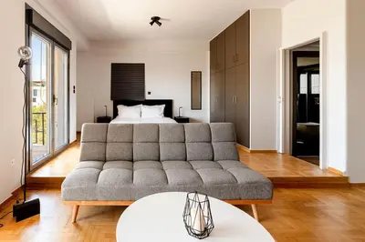 a living room with a couch and a bed at Boutique39 Luxury Apartment Glyfada Athens in Athens