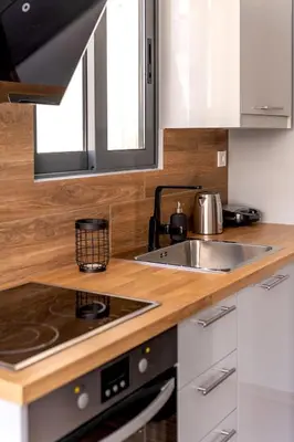 a kitchen with a sink and a stove at Boutique39 Luxury Apartment Glyfada Athens in Athens