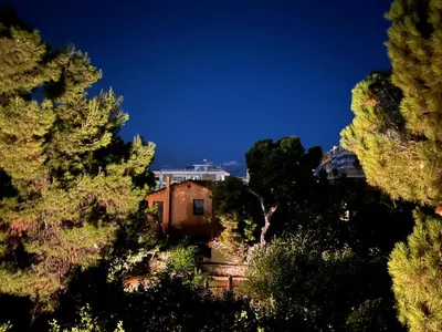a house in the middle of a forest of trees at Beach of Voula in Athens