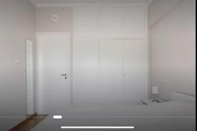 a room with white walls and a door and a room with at Beach of Voula in Athens