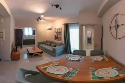 a living room with a table and a couch at Katia Athens Apartment in Athens