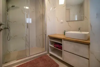 a bathroom with a sink and a shower at Katia Athens Apartment in Athens