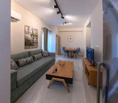 a living room with a couch and a table at Katia Athens Apartment in Athens