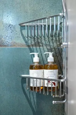 two bottles of soap on a rack in a bathroom at The Meta Stay - Rooftop Access Unique Suite in Athens