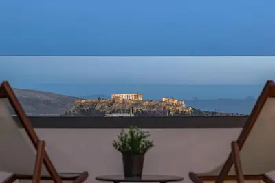 a view of the acropolis from a room with chairs at The Meta Stay - Rooftop Access Unique Suite in Athens