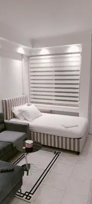 a bedroom with a large bed and a window at Alema Apartment in Athens