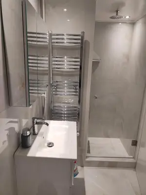 a white bathroom with a sink and a shower at Alema Apartment in Athens