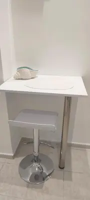 a white table with a plate on top of it at Alema Apartment in Athens