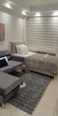 a living room with two beds and a couch at Alema Apartment in Athens