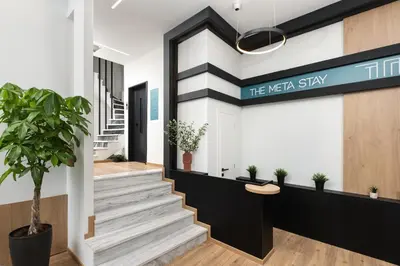 a lobby of the mea stay with stairs and plants at The Meta Stay - Rooftop Access Unique Penthouse in Athens