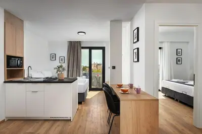 a kitchen and a living room with a bedroom at The Meta Stay - Rooftop Access Unique Penthouse in Athens