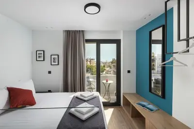 a bedroom with a bed with a blue accent wall at The Meta Stay - Rooftop Access Unique Penthouse in Athens