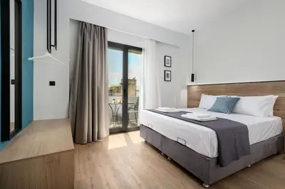 a bedroom with a large bed and a balcony at The Meta Stay - Rooftop Access Unique Penthouse in Athens
