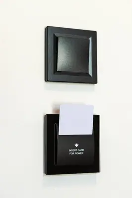 a black box with a white card and a picture at The Meta Stay-Rooftop Access Sunny Suite in Athens