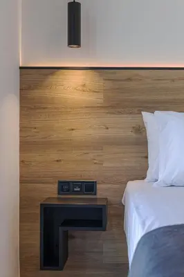 a hotel room with a bed and a night stand at The Meta Stay-Rooftop Access Sunny Suite in Athens