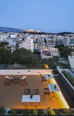 a balcony with tables and chairs and a view of a city at The Meta Stay-Rooftop Access Sunny Suite in Athens