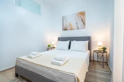 a bedroom with a large white bed with two towels at Cozy central apartment for 2 person by MPS in Athens