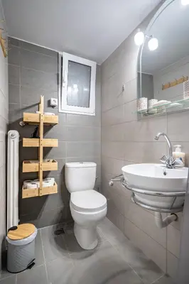 a bathroom with a white toilet and a sink at Cozy central apartment for 2 person by MPS in Athens