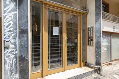 a store front with glass doors on a building at Cozy central apartment for 2 person by MPS in Athens