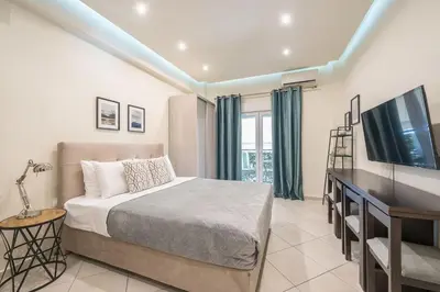 a bedroom with a bed and a flat screen tv at Cozy Apartment in Athens