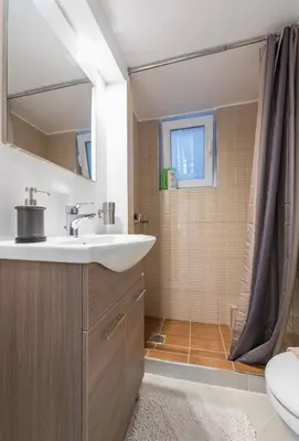 a bathroom with a sink and a shower at Cozy Apartment in Athens