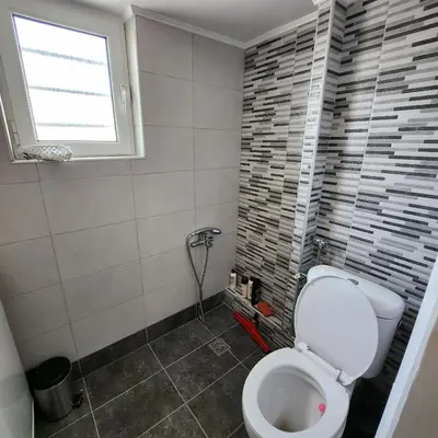 a bathroom with a toilet and a window at Elite Port in Piraeus