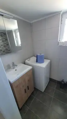 a bathroom with a sink and a toilet and a mirror at Elite Port in Piraeus
