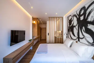 a bedroom with a large bed and a flat screen tv at Athensis Acropolis View next to Ermou street! in Athens