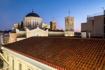 a view of a building with a tile roof at Athensis Acropolis View next to Ermou street! in Athens