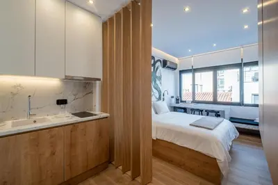 a bedroom with a bed and a sink and a bathroom at Athensis Acropolis View next to Ermou street! in Athens