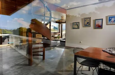 a staircase in a living room with a table at Outstanding Athens Apartment Karyatis Luxury Maisonette 3 Bedrooms in Athens