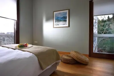 a bedroom with a bed with a bowl of fruit on it at Outstanding Athens Apartment Karyatis Luxury Maisonette 3 Bedrooms in Athens