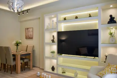 a living room with a tv and a dining room at Apartment in Alimos in Athens