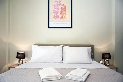 a bedroom with a bed with two towels on it at Apartment in Alimos in Athens