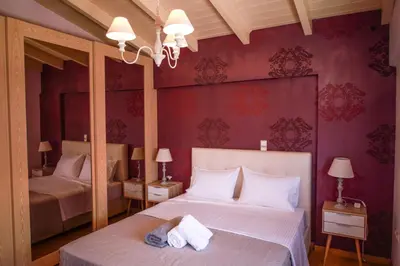 a bedroom with two beds and purple walls at Luxury Villa with Pool in Athens Riviera in Lagonissi