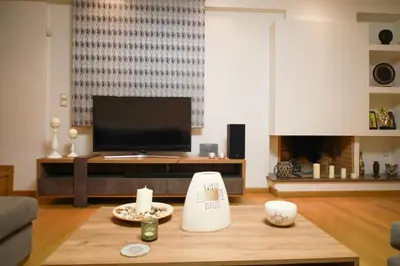 a living room with a tv and a coffee table at Luxury Villa with Pool in Athens Riviera in Lagonissi