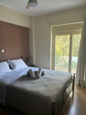 a bedroom with a large bed with two pillows on it at Luxury Villa with Pool in Athens Riviera in Lagonissi